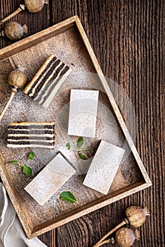 Layered poppy seed cake dusted with powdered sugar