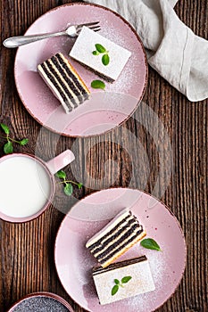 Layered poppy seed cake dusted with powdered sugar