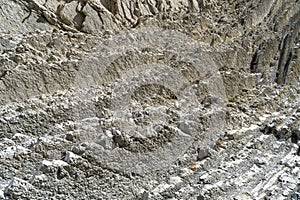 Layered rocks, flysch texture background. Sedimentary rock, striations stone pattern