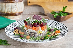 Layered salad with beets, carrots and herring