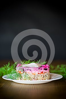 Layered salad of boiled vegetables with beets and herring