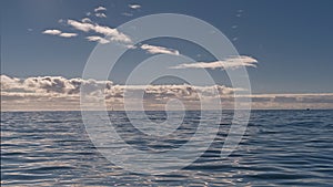 Layers of clouds on a blue sky over the Atlantic ocean