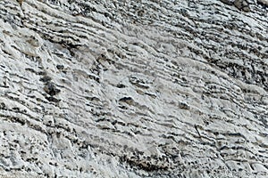 Layers of dark flint pebbles in limestone