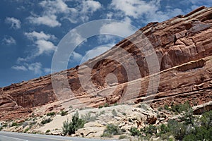 Layers of Entrada and Navajo sandstone lining the road in Arches National Park in Moab, Utah