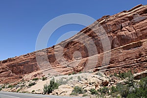 Layers of Entrada and Navajo sandstone lining the road in Arches National Park in Moab, Utah photo