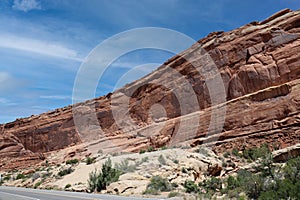 Layers of Entrada and Navajo sandstone lining the road in Arches National Park in Moab, Utah photo