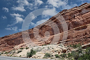 Layers of Entrada and Navajo sandstone lining the road in Arches National Park in Moab, Utah photo