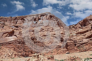 Layers of Entrada Sandstone behind the road leading into Arches National Park