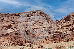 Layers of Entrada Sandstone behind the road leading into Arches National Park in Moab, Utah