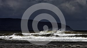 Layers of an incoming tide and storm on the Downhill Beach in the Downhill Demesne in County Londonderry in Northern Ireland.