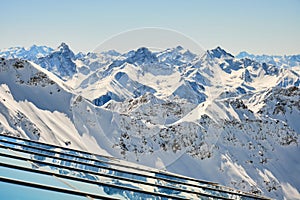 Layers of mountain peaks reflected on glass - view from Parpaner Rothorn upper cable station in Arosa Lenzerheide resort