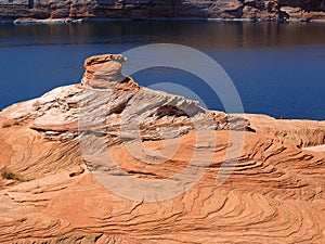 Layers of rock form a weathered spire at Lake Powell in Arizona