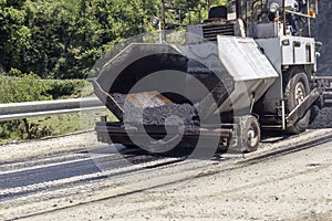 Laying asphalt in the mountains on a narrow road