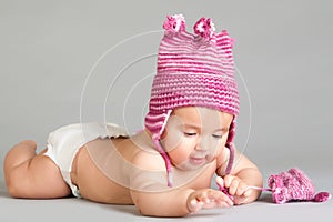 Laying baby in stripy pink cap