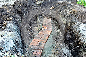 Laying and backfilling a fragment of an underground cable line of low depth