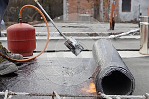 Laying Bitumen Insulation with Gas Blowtorch on a Concrete Slab