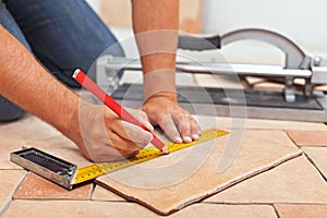 Laying ceramic floor tiles - man hands closeup