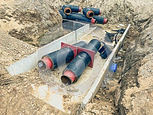 Laying communications for residential buildings. laying rubber pipes for water and plumbing, sewage disposal. black pipes with red
