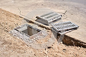 Laying concrete manholes and drain pipes for stormwater system. Connecting a trench drain to a concrete manhole