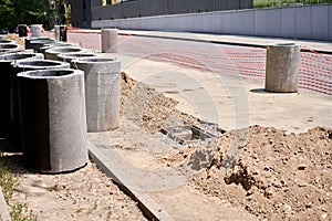 Laying concrete manholes and drain pipes for stormwater system. Connecting a trench drain to a concrete manhole