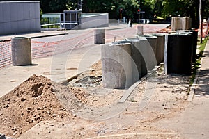 Laying concrete manholes and drain pipes for stormwater system. Connecting a trench drain to a concrete manhole