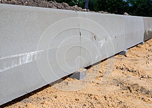 Laying curbs during the construction of sidewalks