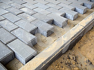 Laying curbs at the edge of the path