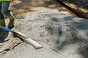 Laying down a new sidewalk in wet concrete on freshly poured sidewalks