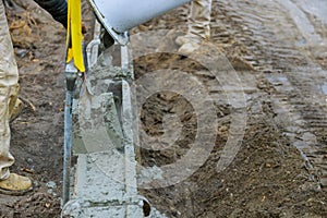 Laying down pouring cement during sidewalk