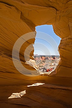 Laying down resting in the sun under an arch in the Coyote Buttes Wilderness of northern Arizona