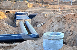 Laying drain pipes and concrete manholes for stormwater system. Connecting a trench drain to a concrete manhole structure