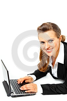 Laying on floor business woman using laptop