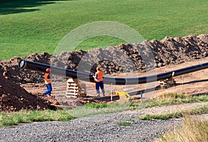 Laying a gas pipe route on the construction site with worker