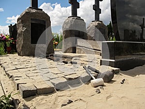 Laying granite pavers in the cemetery