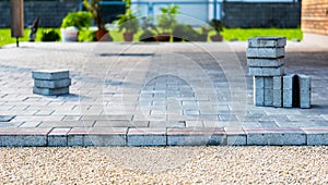 Laying gray concrete paving slabs in house courtyard driveway pa