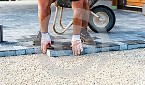 Laying gray concrete paving slabs in house courtyard driveway pa