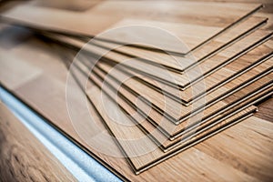 Laying laminate wood floor in the room - repair and finishing work.