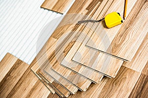 Laying laminate wood floor in the room - repair and finishing work.