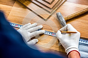 laying laminate wood floor in the room - repair and finishing work.