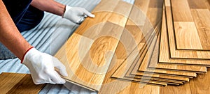 Laying laminate wood floor in the room - repair and finishing work.