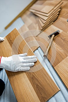 laying laminate wood floor in the room - repair and finishing work.