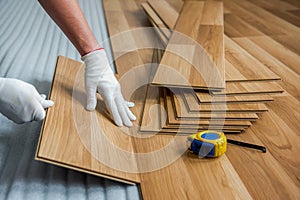 laying laminate wood floor in the room - repair and finishing work.