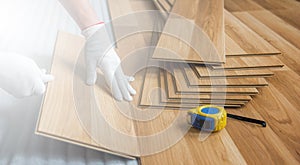 Laying laminate wood floor in the room - repair and finishing work.