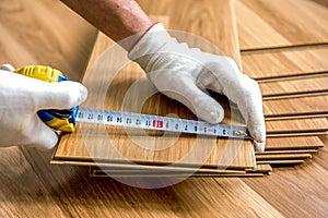 laying laminate wood floor in the room - repair and finishing work.