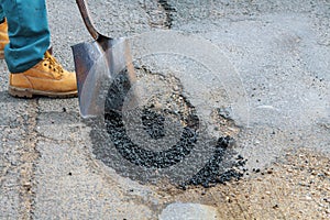 Laying new asphalt, covering the pit, very bad quality road with hole in asphalt