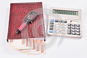 The laying out of money in calendar, calculator and magnifier