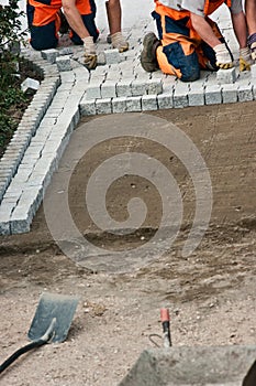 Laying paving bricks on soil