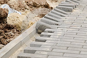 Laying of paving slabs to curb