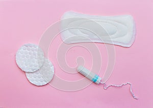 Laying on a pink background. Feminine hygiene products: pad, swab. on a pink background