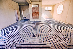 Laying pipes for floor heating at the construction site of the h